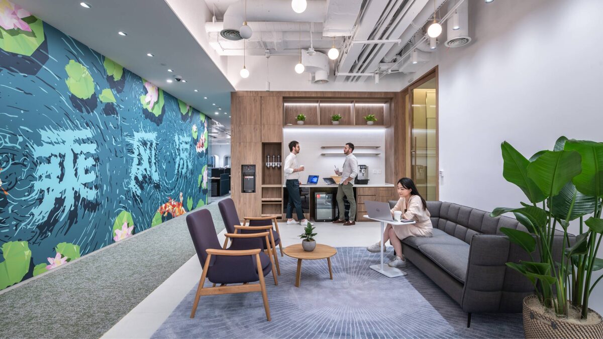 people working in lounge near teapoint