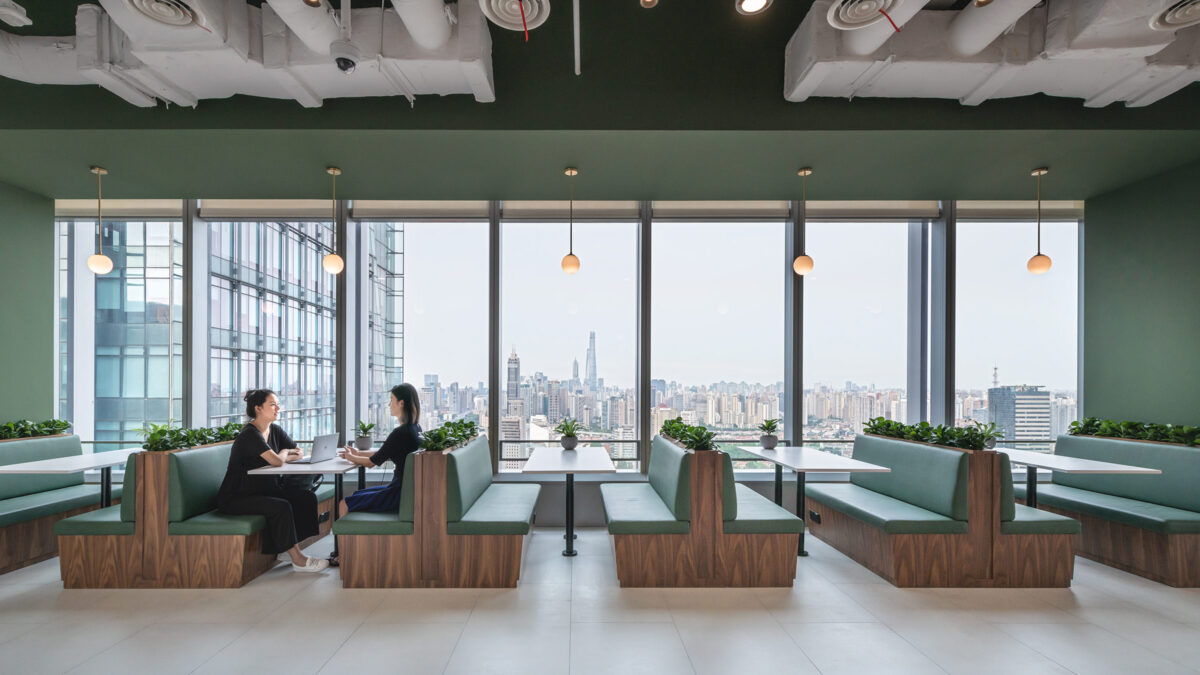 people working in booths with views