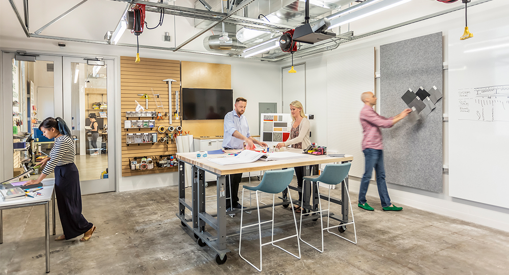 people collaborating at desk with materials