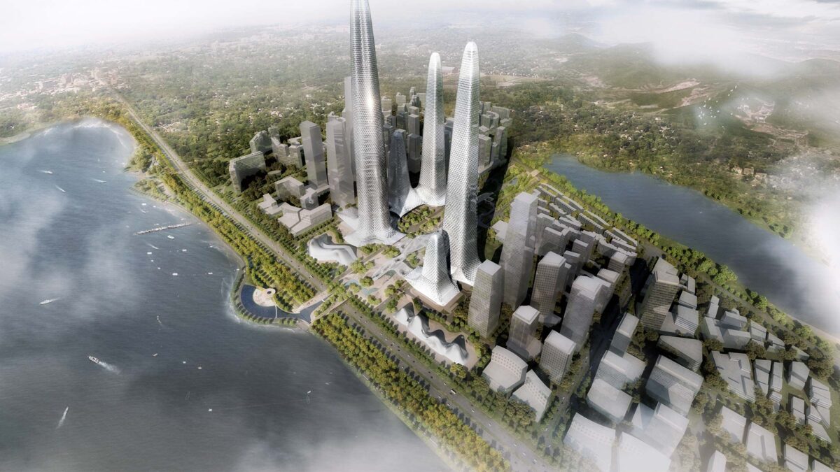 Overhead shot of building amongst city and surrounding trees