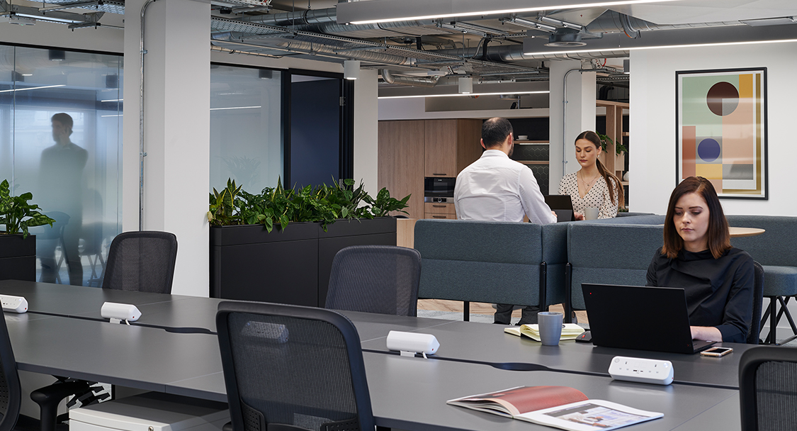 woman working at desk and people working