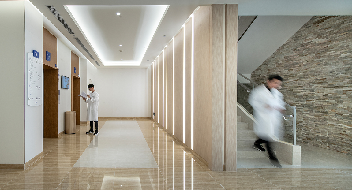 man walking down staircase and man waiting for lift