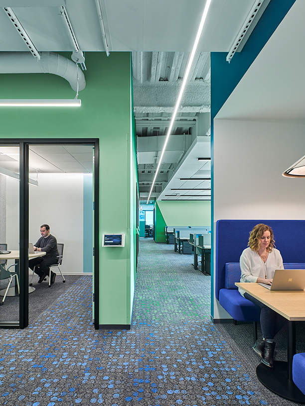 woman in booth and man in meeting room