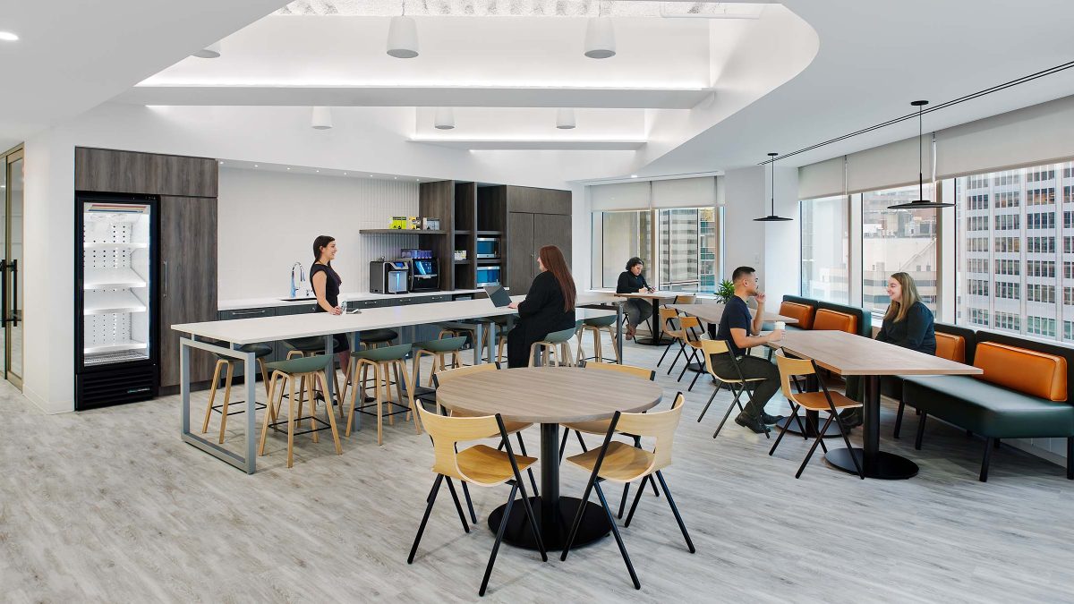 Office design by M Moser in New York for BBR Partners featuring inviting kitchen and lounge seating for employees.