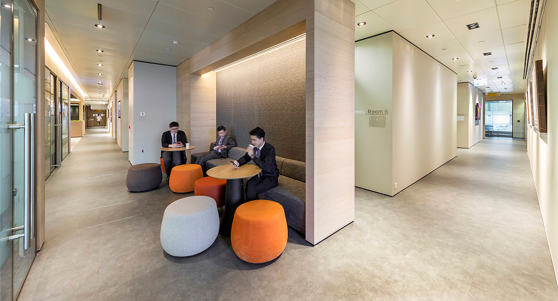 people collaborating in booth, grey and orange small seat