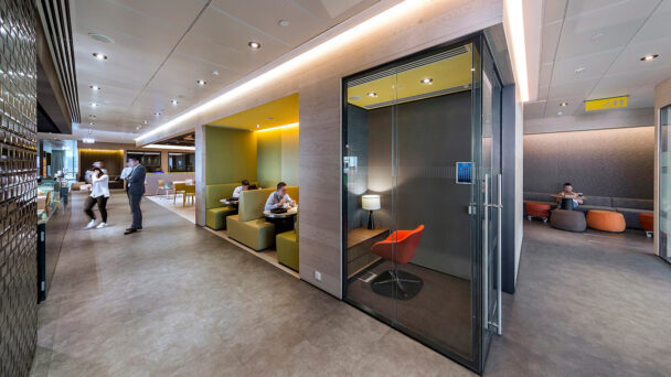 people collaborating in booths and in the kitchen