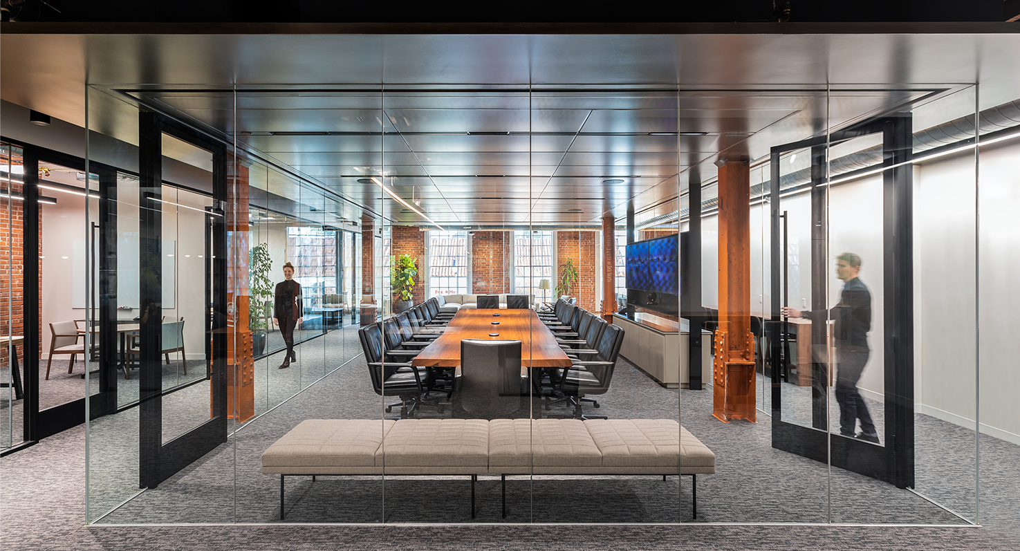 man opening boardroom door woman on other side