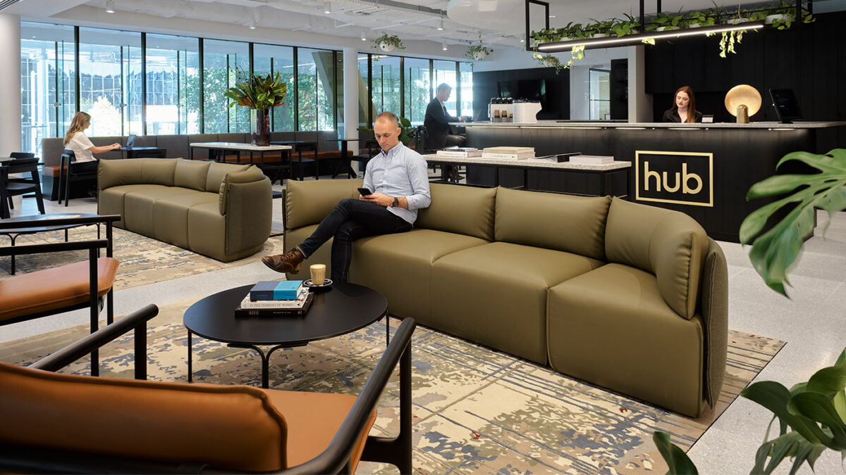 reception and man sitting in lounge area