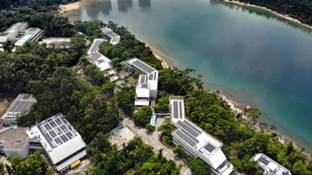 overhead shot of building and surrounding sea and trees