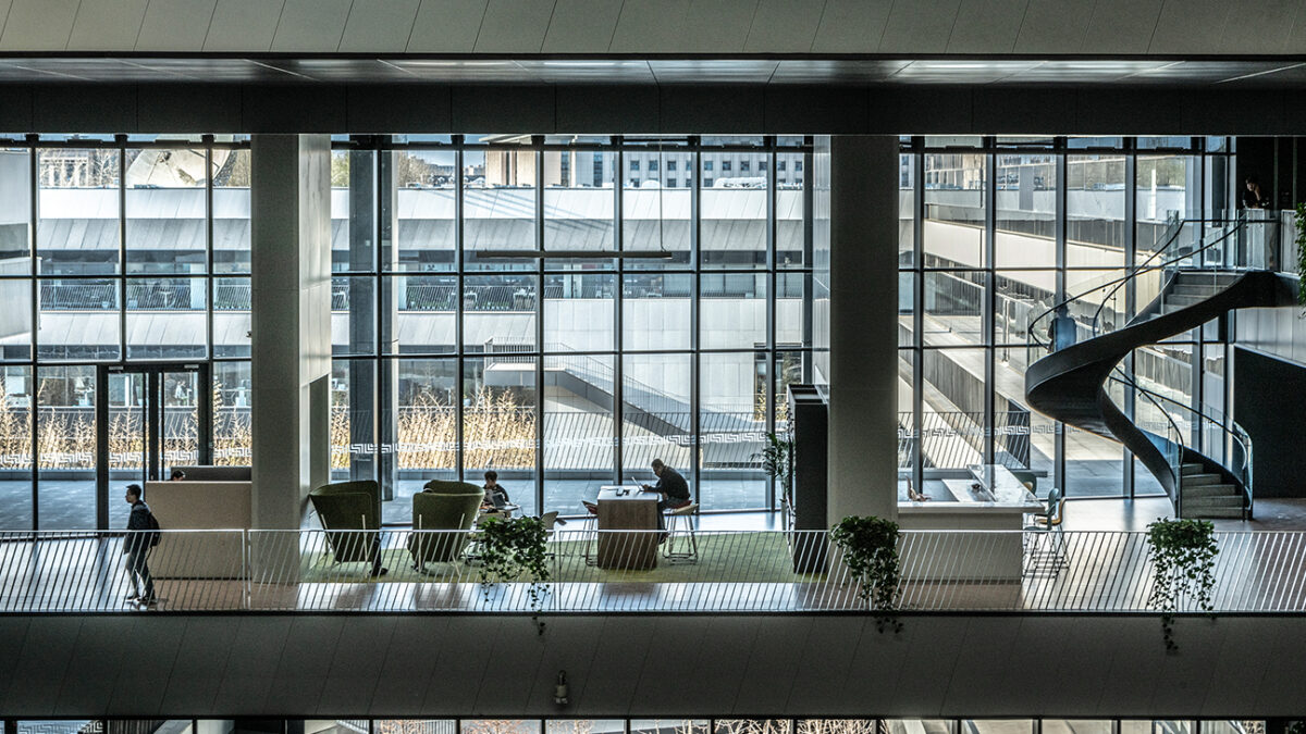 People working in open plan space and staircase visible