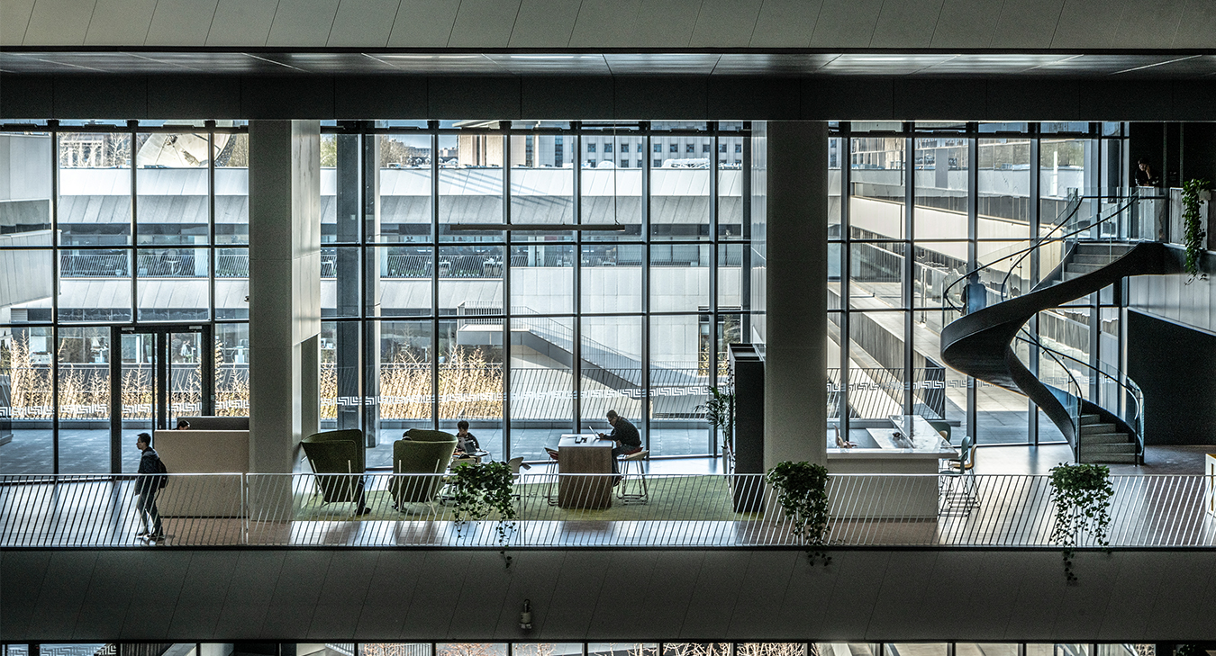 People working in open plan space and staircase visible