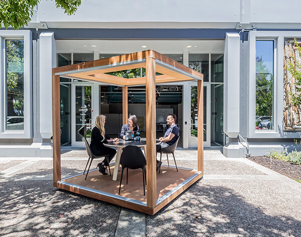 people working outdoor in framed wooden booth