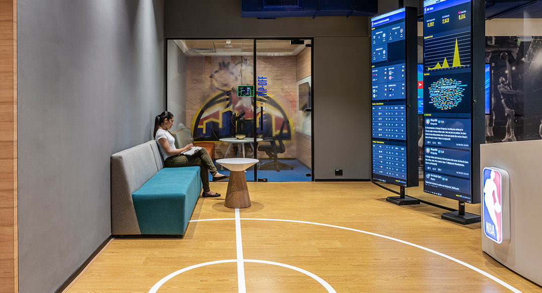 woman sitting in front of screens