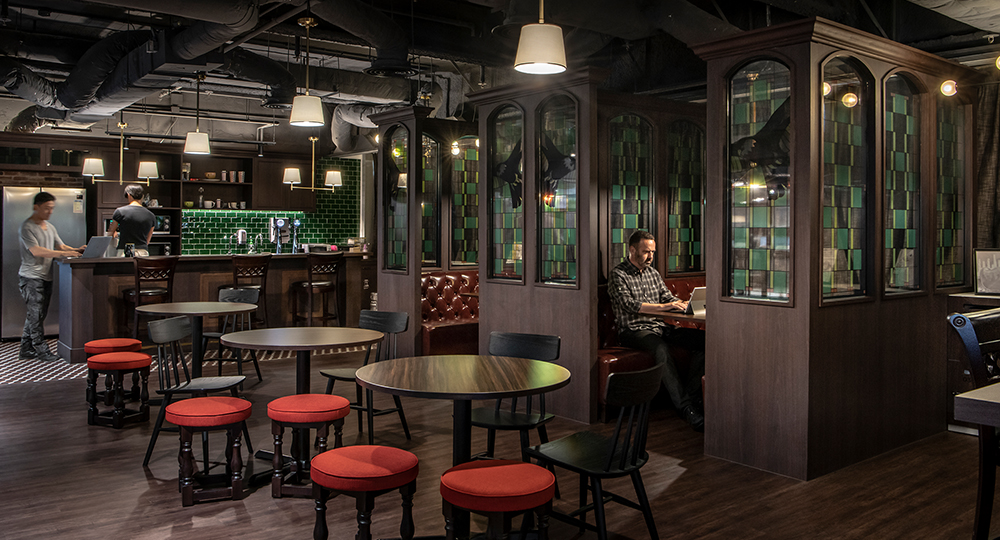 man working in booth near bar