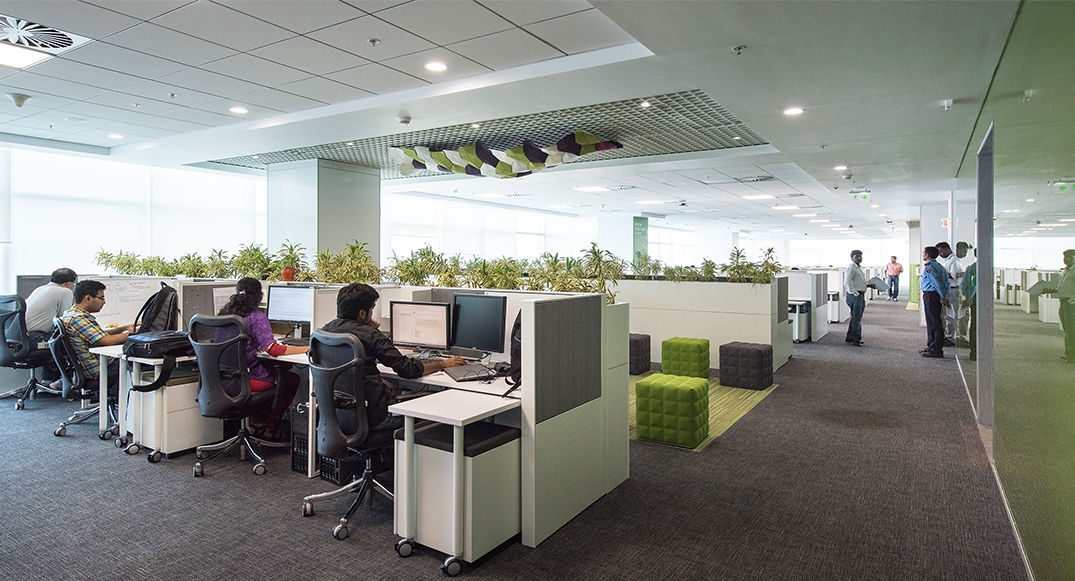 people at desks on computers and people collaborating