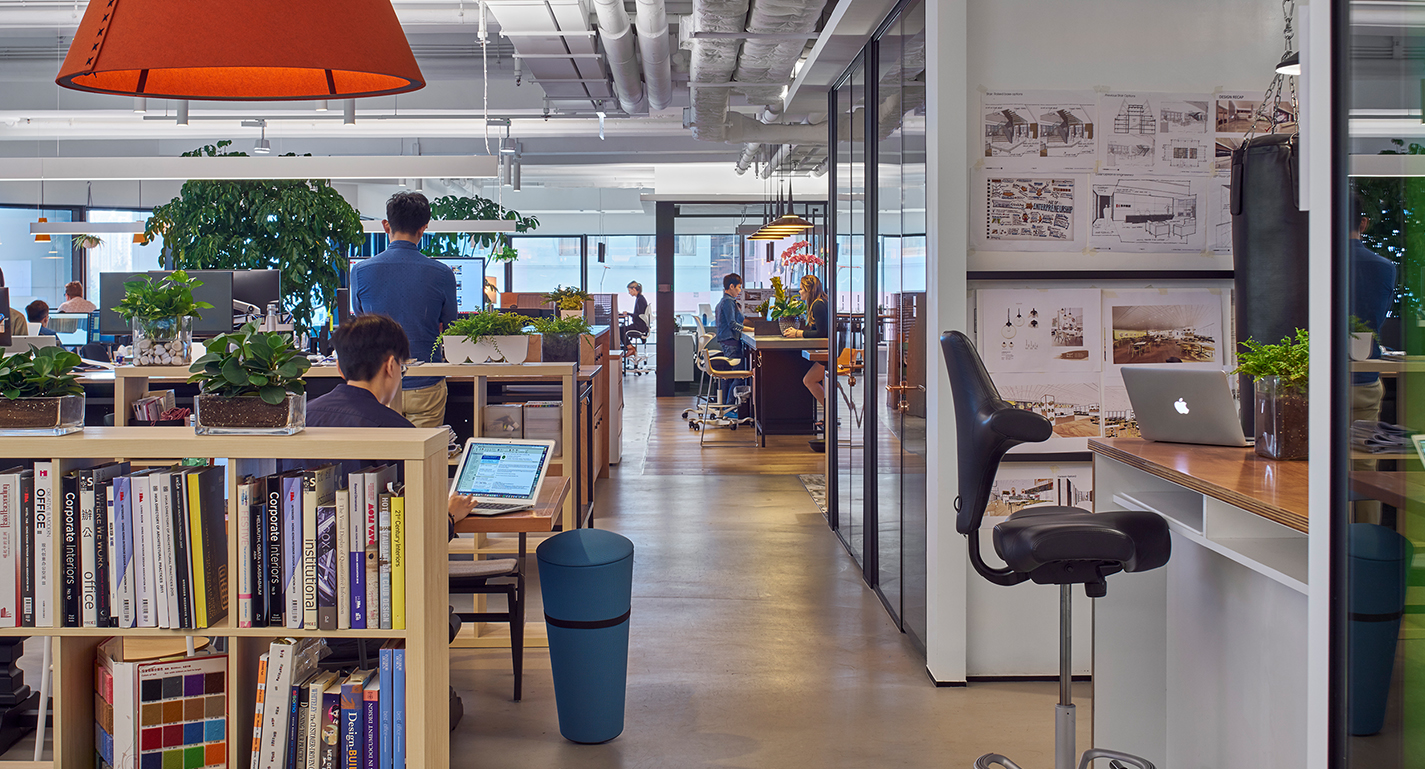 people at desks and bookcase