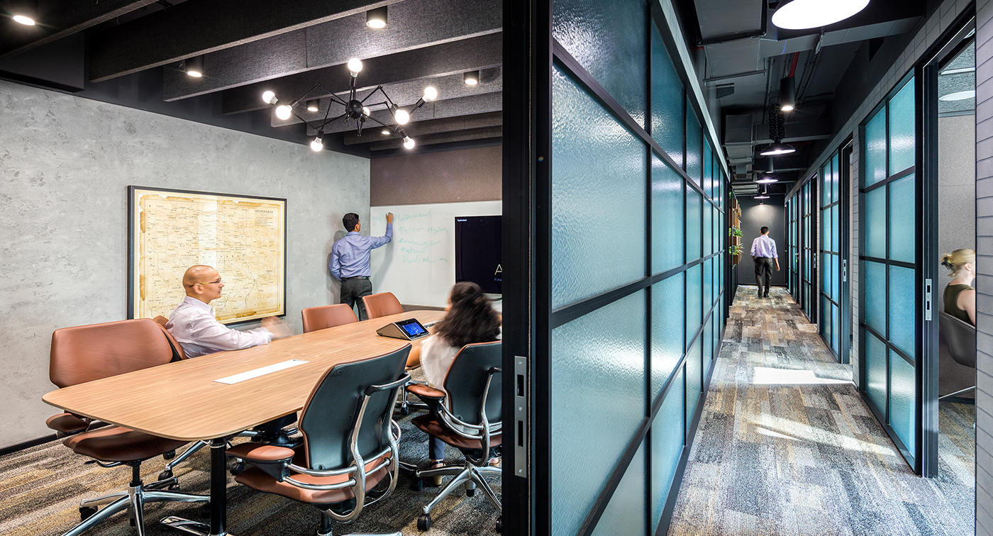 people collaborating in meeting rooms and corridor