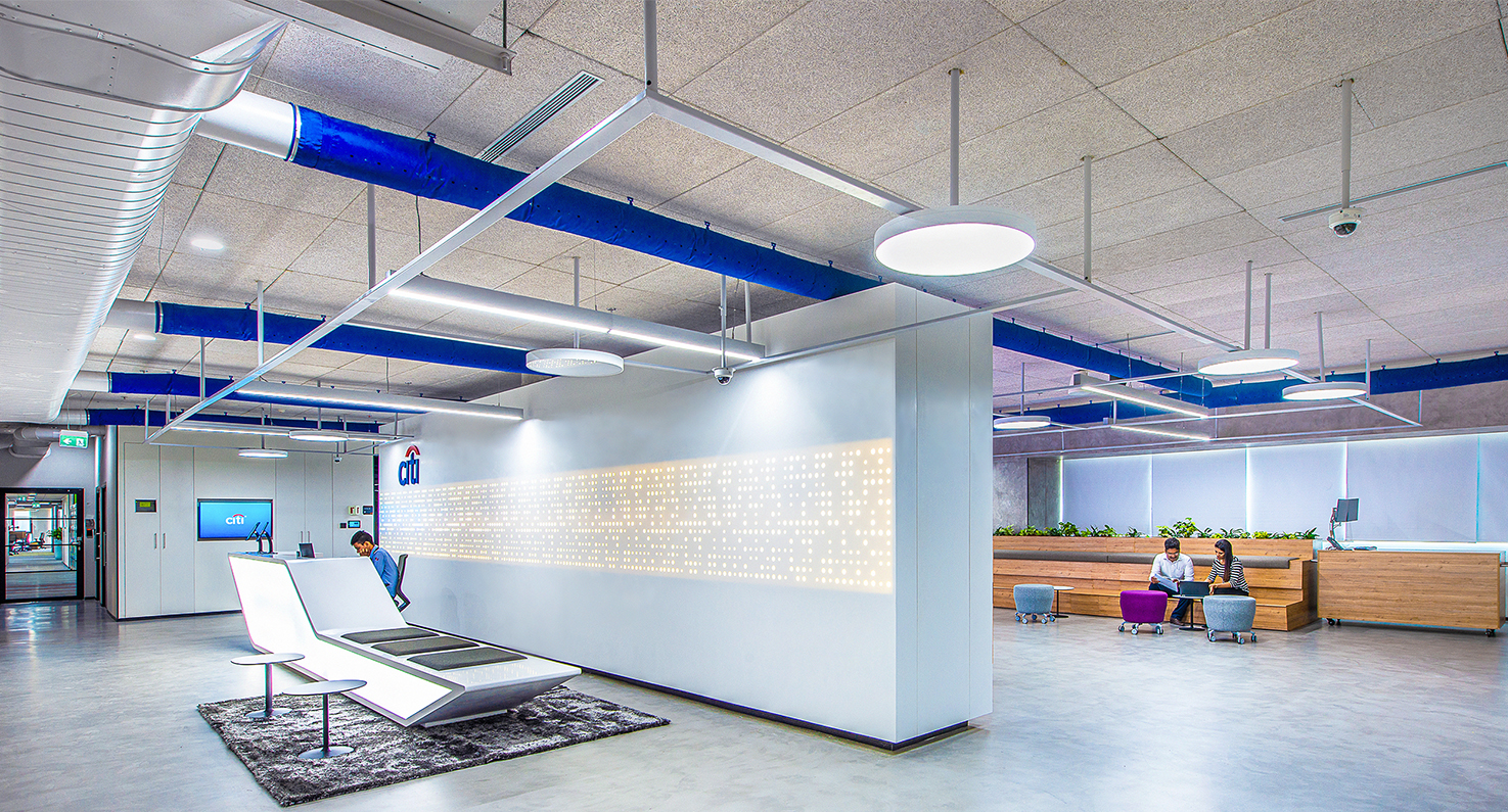 reception desk and people collaborating behind wall