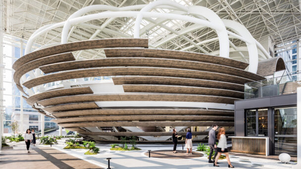 people walking around spherical dome staircase