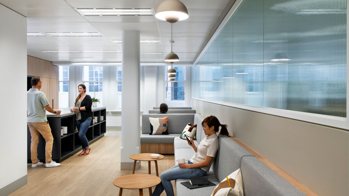 person in open plan workplace booth