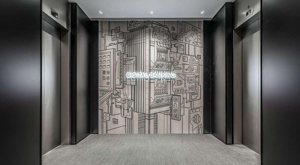 corridor with lift and wall art