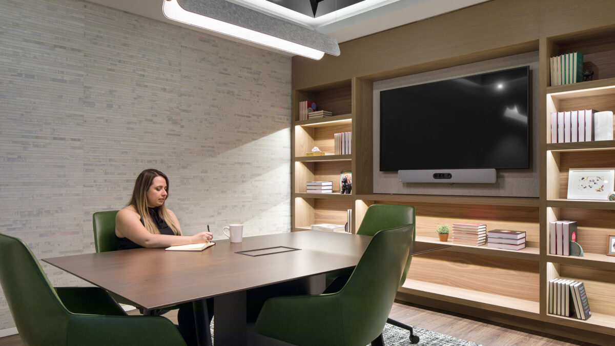 woman writing in meeting room