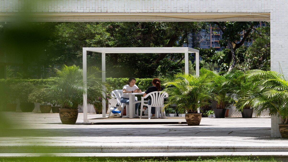 students sitting outside in green