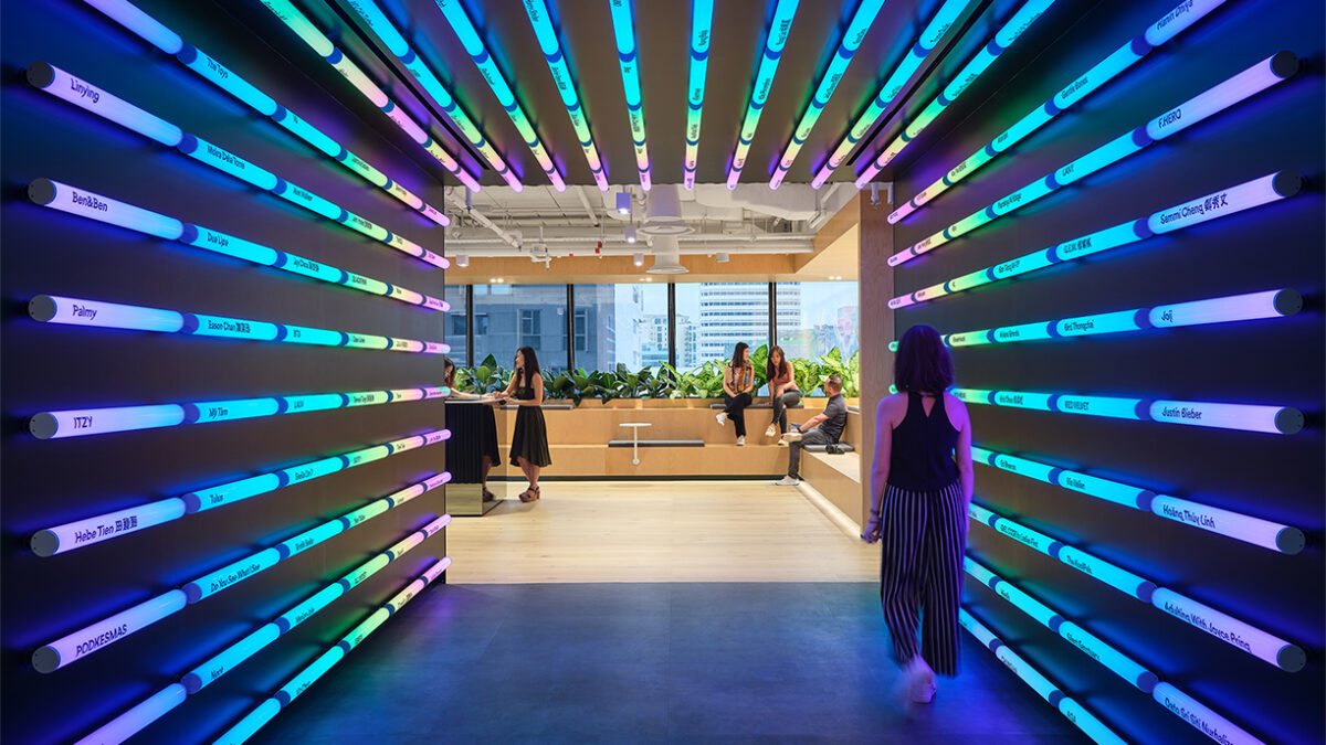 woman walking through corridor with fluorescent lighting