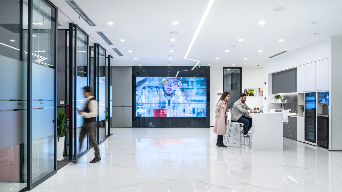 people in kitchen, man walking into meeting room and av wall large version