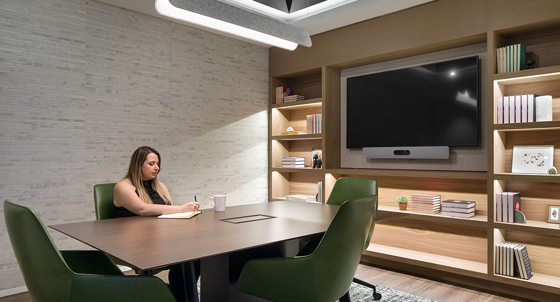 woman writing in meeting room