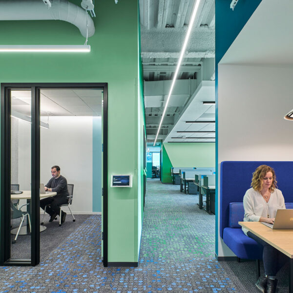 woman in booth and man in meeting room