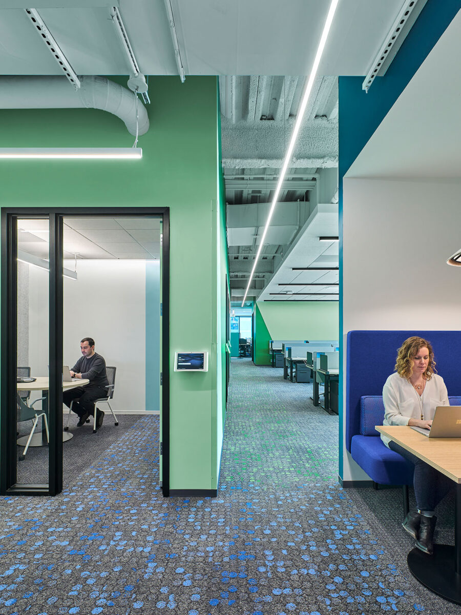 woman in booth and man in meeting room
