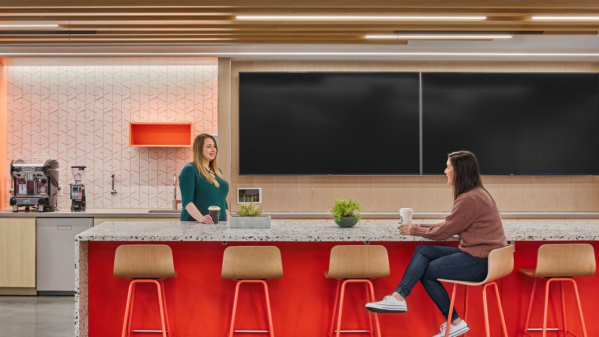Café setting at Adobe with bright colours and a terrazzo countertop to offer employees a unique break and rest area.
