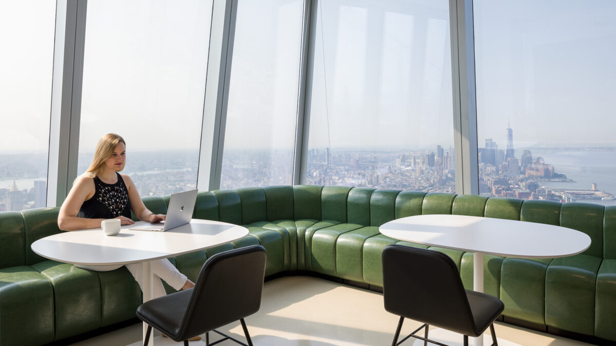 person working in booth breakout in office design for DNB