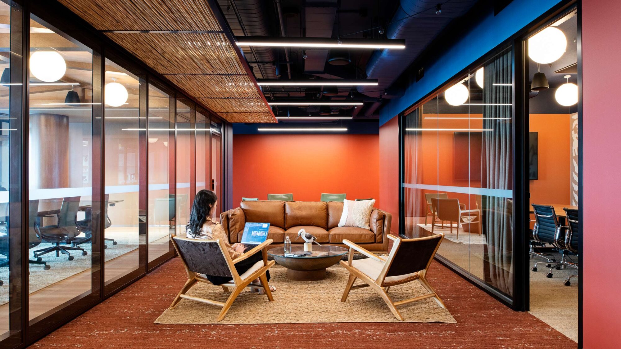 person working in sitting area in Epic office design work