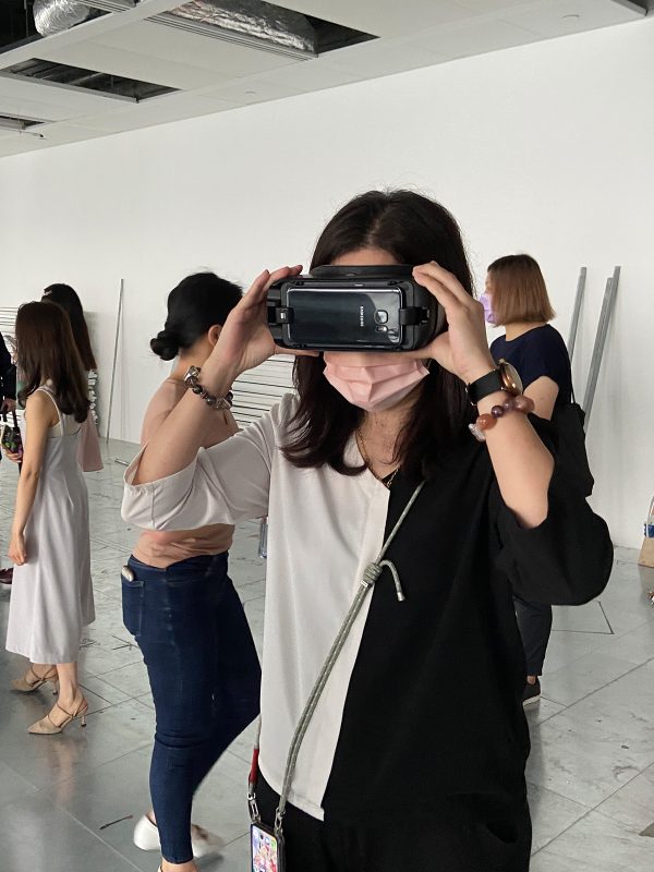woman using VR glasses to see office layout 