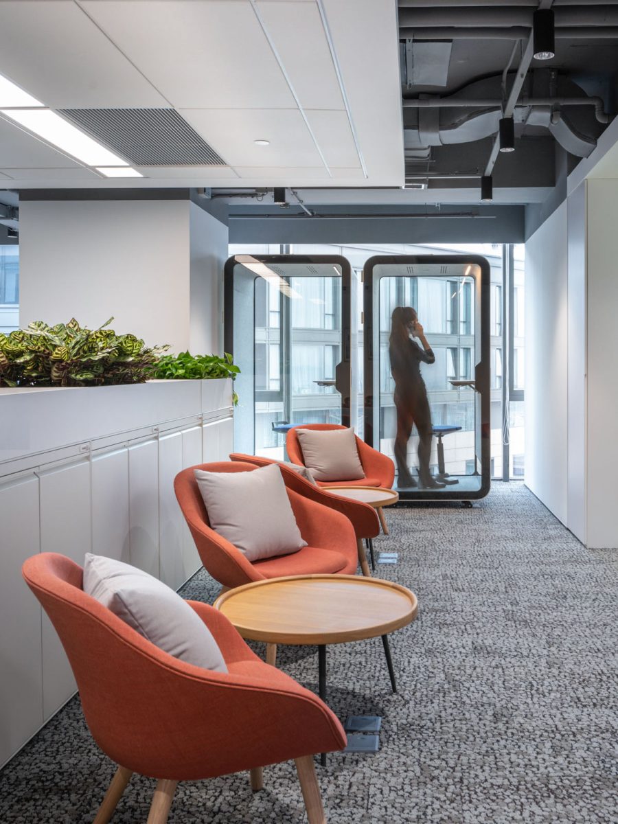 Office common space interior design orange and wooden furniture