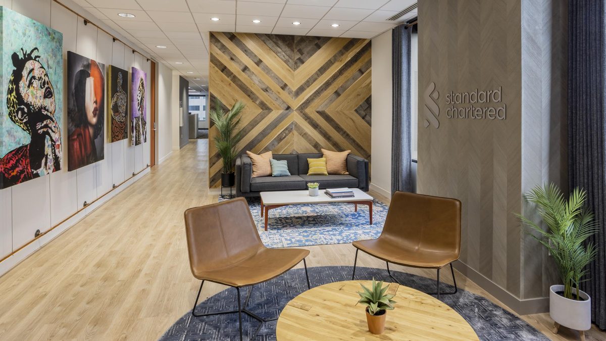 Custom-designed office by M Moser featuring a reception area, coworking space, artwork, lounge seating, millwork design and casual workspace in a modern office design.