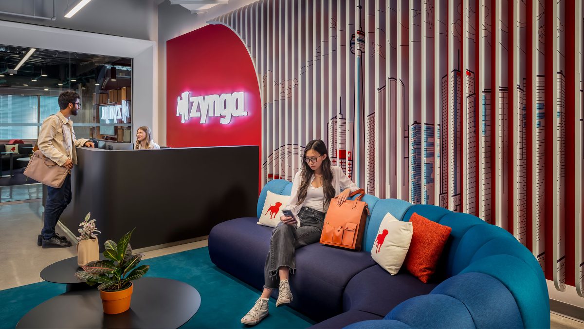 A welcoming reception area at Zynga featuring the artwork of the Toronto skyline behind a comfortable seating area.