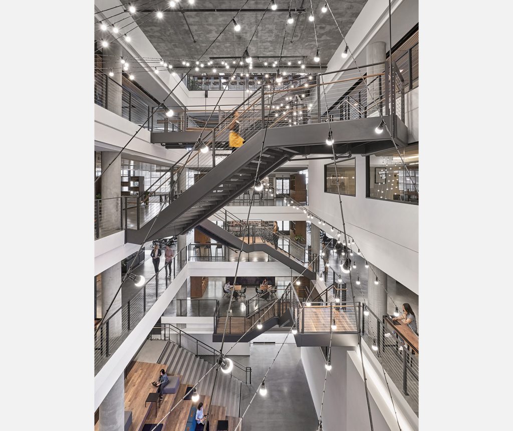 Corporate office architecture featuring large, connected atrium design completed by M Moser architectural engineering and interior design.