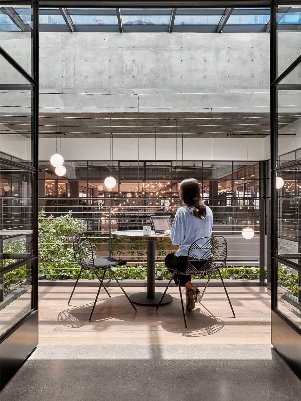 Architectural project for client transforms the core and shell building into a seven-floor office connected by a large stairway and atrium.