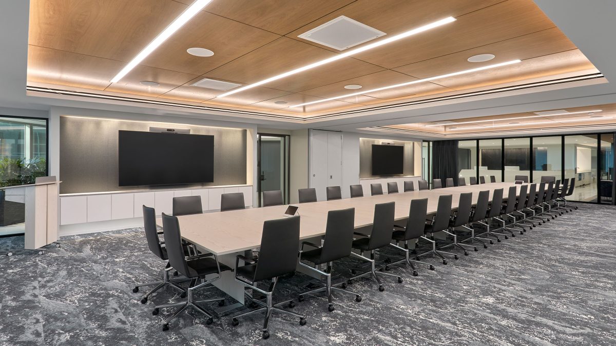 Large boardroom and customer experience centre design by M Moser Associates featuring technology and ergonomic office chairs.