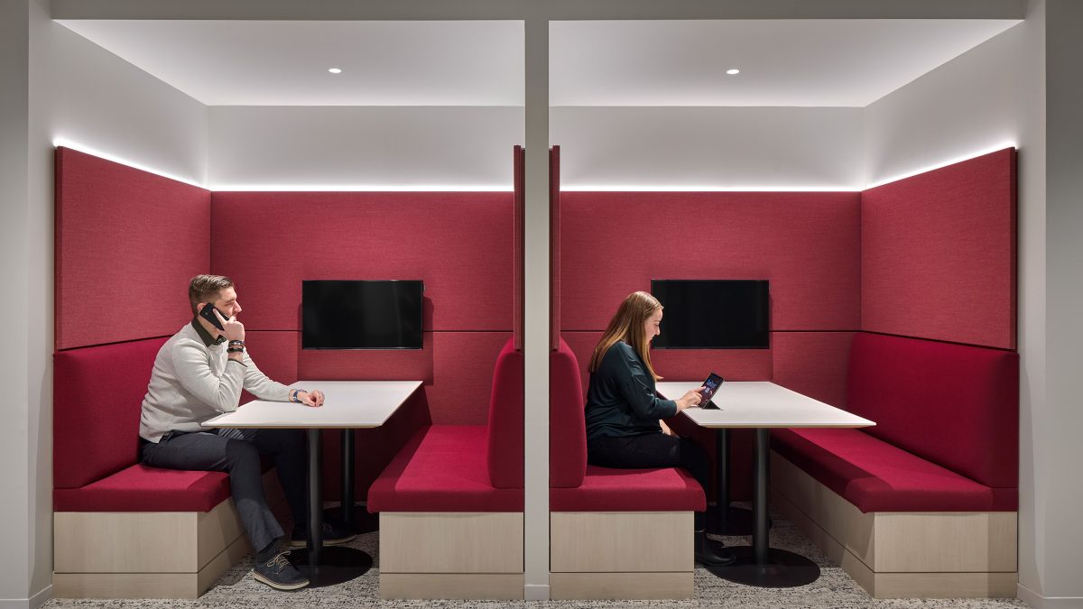 Hospitality-driven interior office design by M Moser in New York featuring comfortable booth seating for individual or heads-down work.