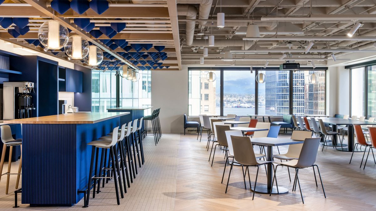 Large corporate kitchen design by M Moser Associates for 200+ employees featuring brand colors and art installation.