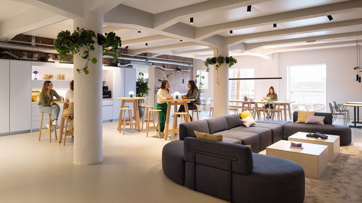 Open view of offices communal lounge and meeting tables.