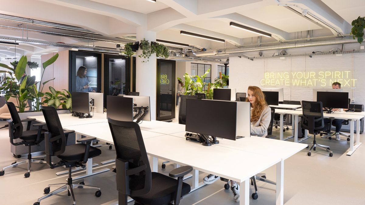 Open plan workstations in office with focus booths for calls