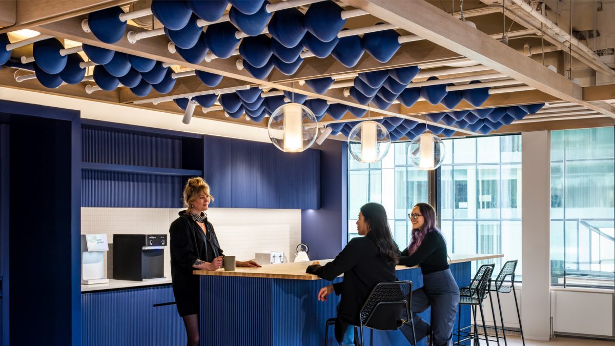 Corporate office interior design featuring a colourful, bright kitchen space for breaks and employee interaction.