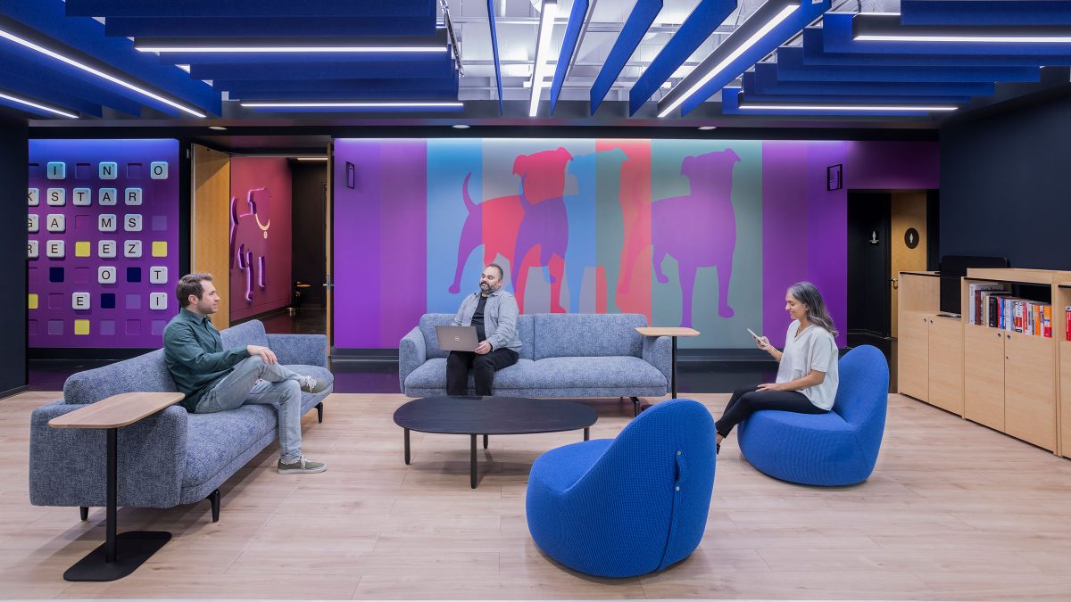 Company environmental branding by M Moser for Zynga’s headquarters in San Mateo, California, featuring neon signage, colourful furniture and interactive elements.