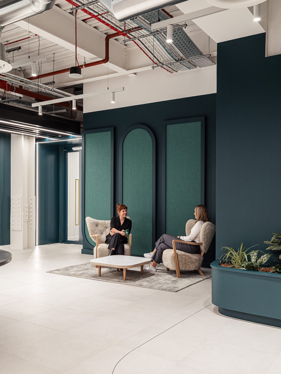 two people sat down and talking in the reception waiting area