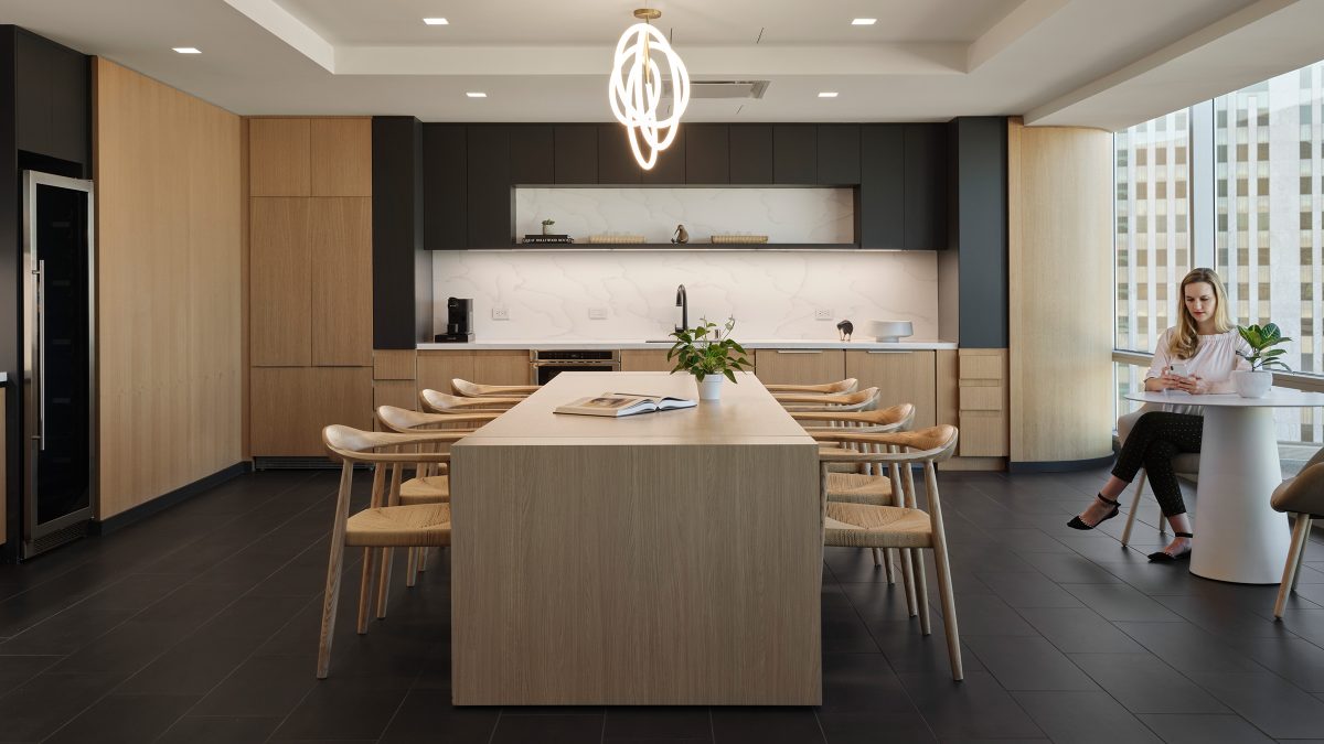 Corporate kitchen design by M Moser in Los Angeles featuring long, family-style table and seating and comfortable nooks or casual working or meetings.